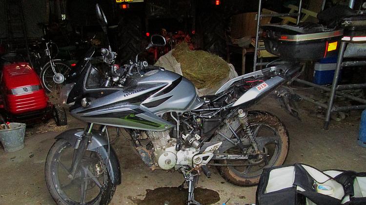 Ren's 125 has the panels and seat off for repairs in a farmer's barn in Scotland