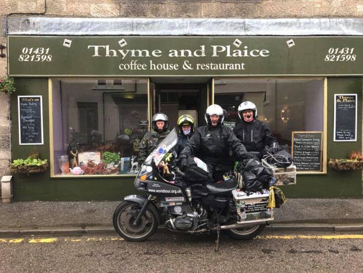 4 of the motorcyclists stood outside the cafe with Bernard's BMW
