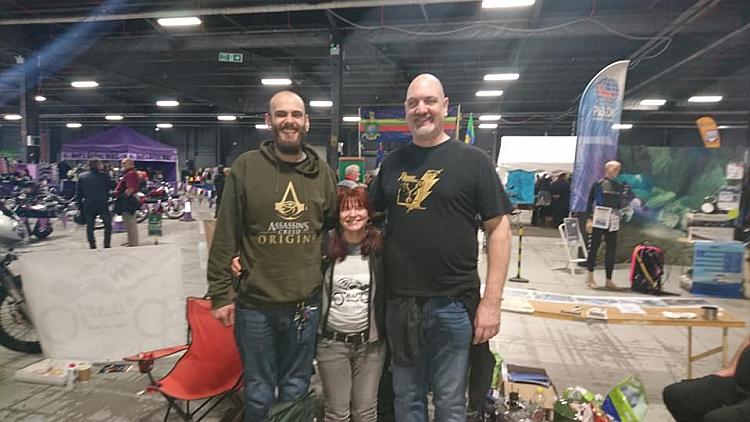 Sharons stands barely at chest height next to two men at 6 feet 7 inches