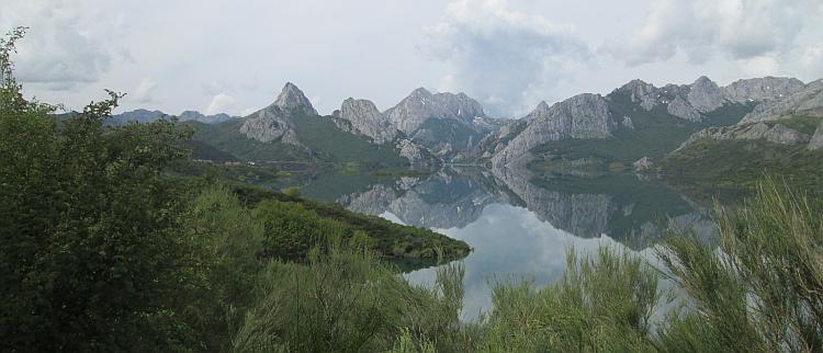 Stunning shot of mountain tops reflected in water in The Picos De Europa