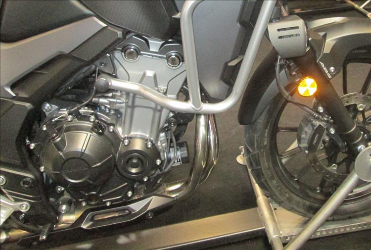 There's no lower fairing or belly pan on the new model, exposing the exhaust and the front of the engine