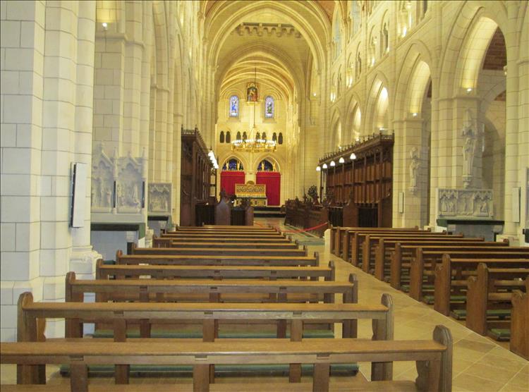 Inside the abbey the columns and ceilings are bright white and the pews are neat