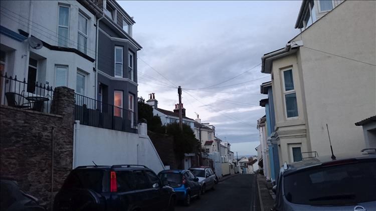 Houses up high and low down and all levels on a street in the town