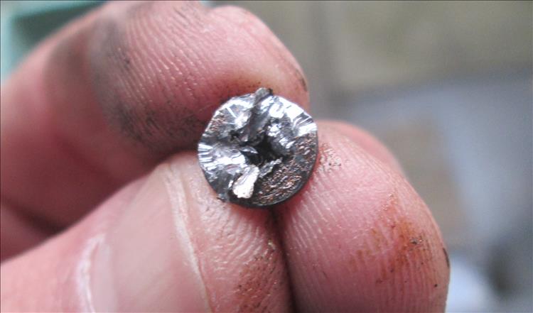 The head of the crosshead bolt is chewed up, cut, chiselled and damaged 