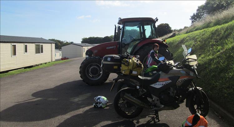 Sharon smiling in blue skies as the motorcycles are loaded with our gear ready to leave