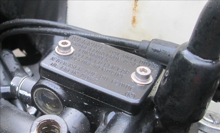 The reservoir on the master cylinder of the brakes has shiny cap headed bolts in it now