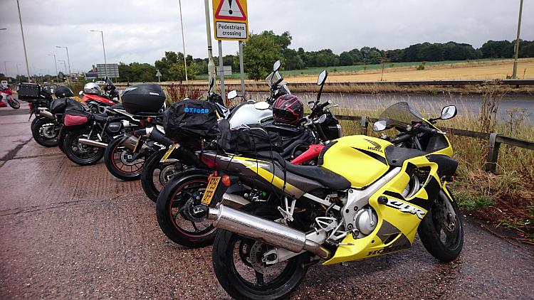 A bright yellow CBR600 at the busy and very wet car park for the meeting