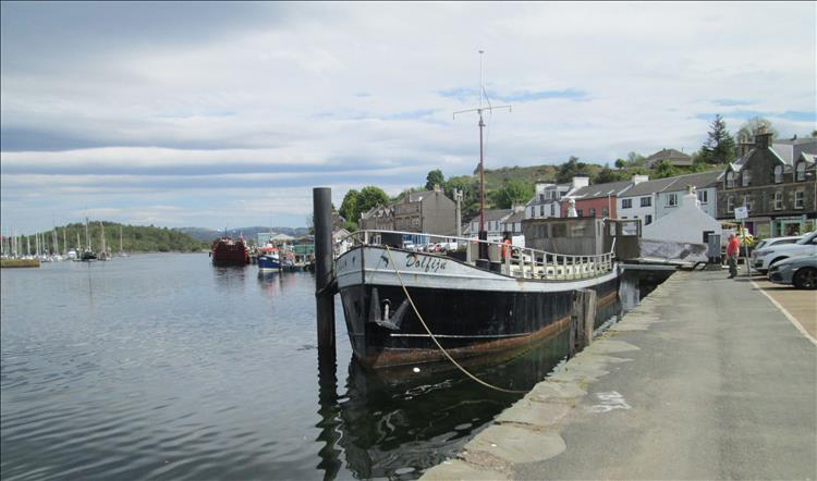 Calm still waters and boats at Tarbert Harbour