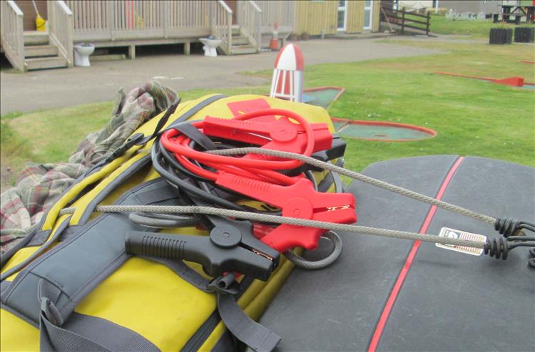 Along with the mountain of camping kit there's now a set of jump leads on Ren's bike