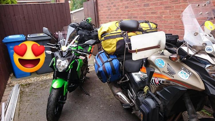 The 2 motorcycles covered in luggage ready to leave Sharon's house