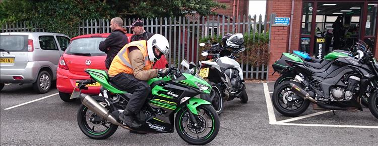 Ren is pretending to race a motorcycle while still stationary in the car park