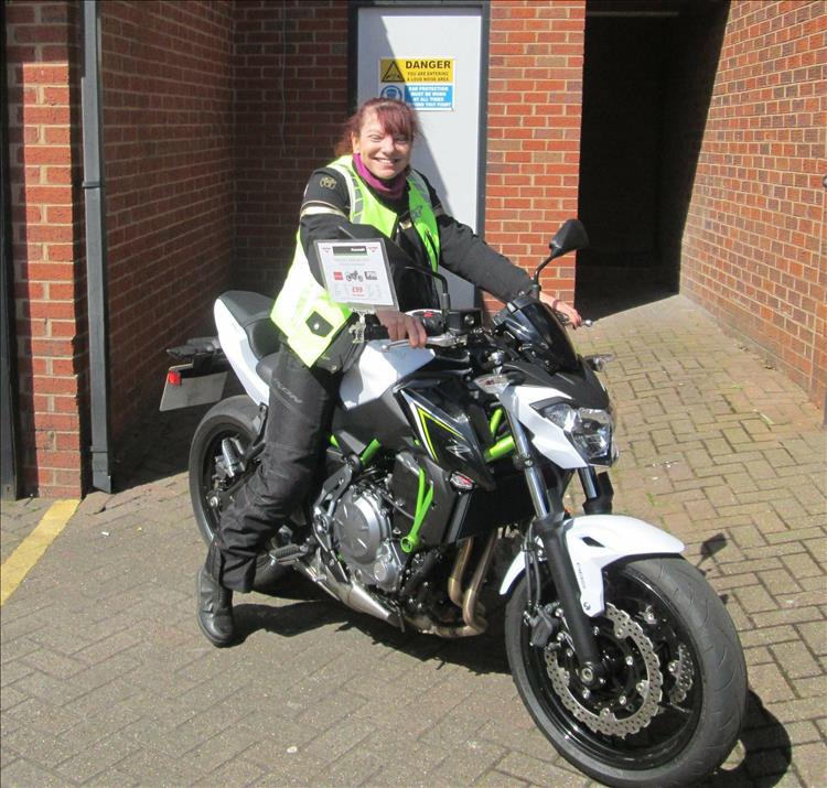 Sharon has a beaming smile sat on a white Kawasaki Z650