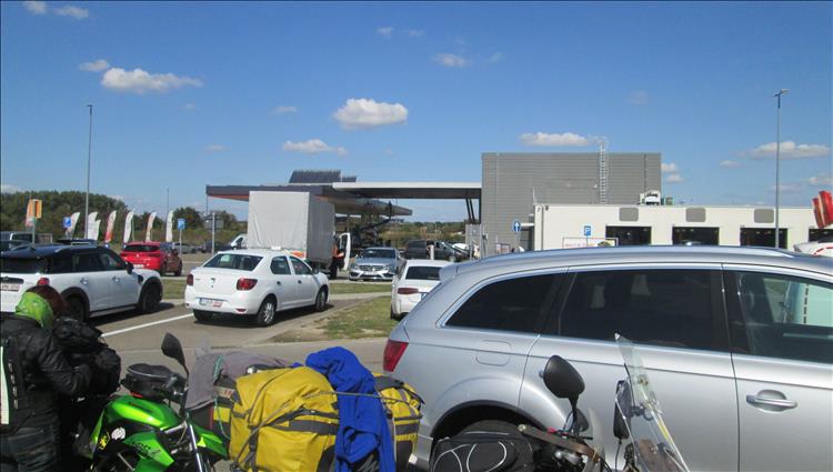Cars, car park, sunshine, petrol station, and sharon keeping her head down