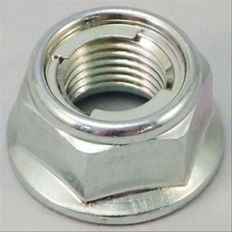 Close up of a nut with a metal insert in the top to prevent the nut from falling off the bolt