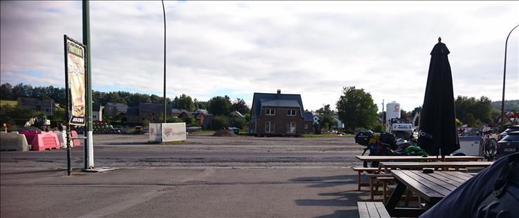 A big main road, an ordinary cafe and regular houses in Belgium