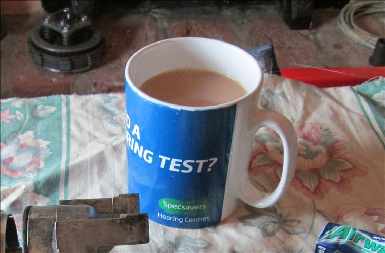 A cup of hot tea with milk in it.