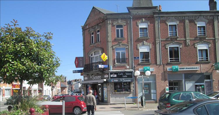 A corner shop with the tabac sign outside on the main street through the town