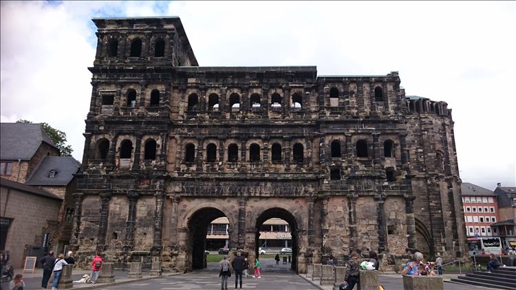 Large sandstone ruins of the huge gateway to the city. The sandstone is black with dirt hence the name