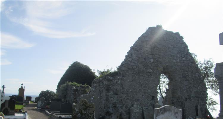 The ancient church is in ruins but recent graves and headstones abound between