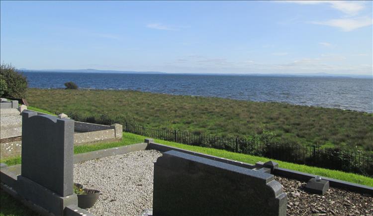 In the close foreground are to modern graves overlooking the vast waters of Lough Neagh