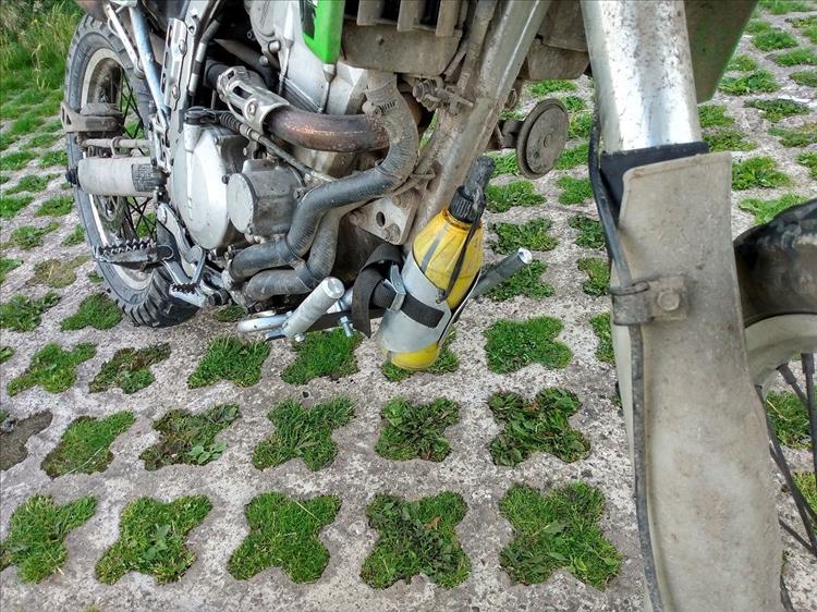 The same footrests are folded up, out the way ready for off road riding