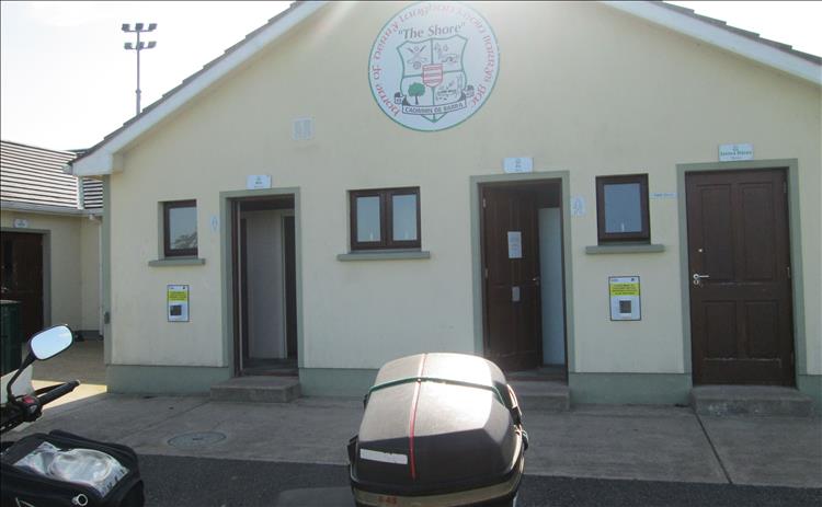 A smart white building with the doors to the toilets open at Derrylaughan