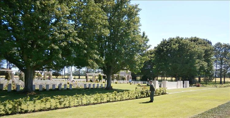 The cemetery with immaculate trimmed grass and rows of headstones at Ryes