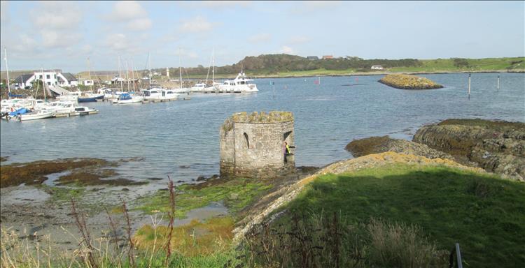 Sharon waves from within the round stone bathing house that looks more like a tiny castle