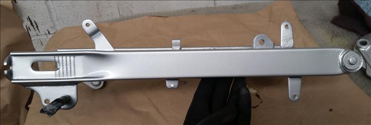 The side of the swingarm now painted, looks like new but we can spot the pits from the rust
