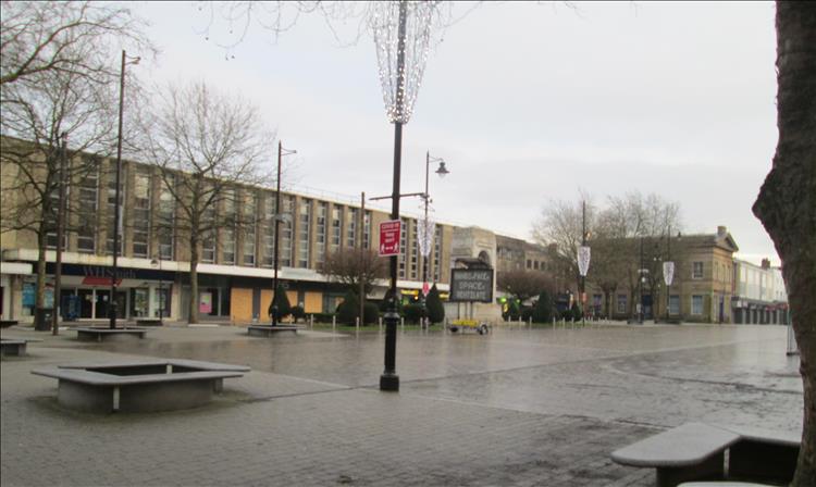 Concrete shops and drab town Square in Bolton