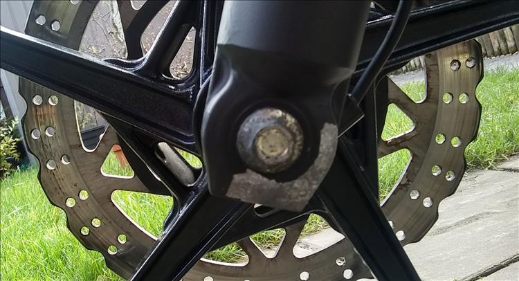 The bottom of the fork has a chunk of paint missing exposing the metal to the elements