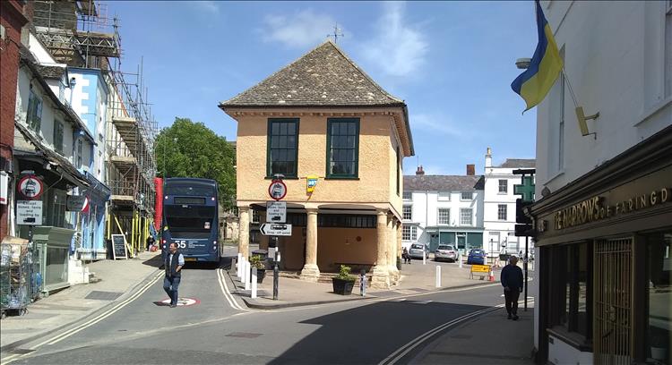 A 2 storey building with an open section on the lower floor supported by pillars