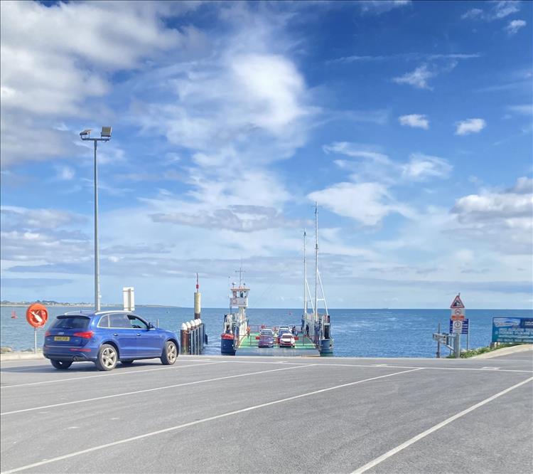 A small vehicle ferry large enough for perhaps 20 cars and the waters of the Carlingford Lough