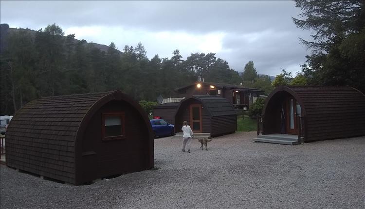 Heavy skies in the early morning, we see the pods and buildings of the campsite