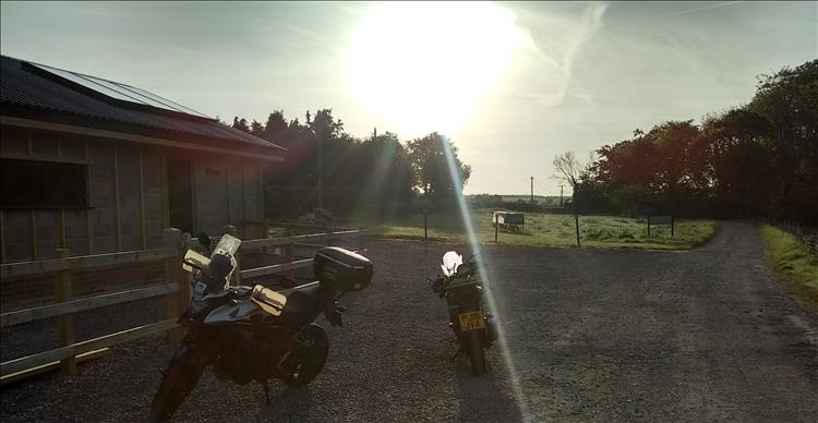 The 2 bikes and an unclad breezeblock build building at the campsite