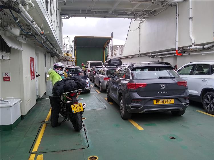 On the deck of the ferry the sides rise high blocking the scenery. All we see are the cars and the boat