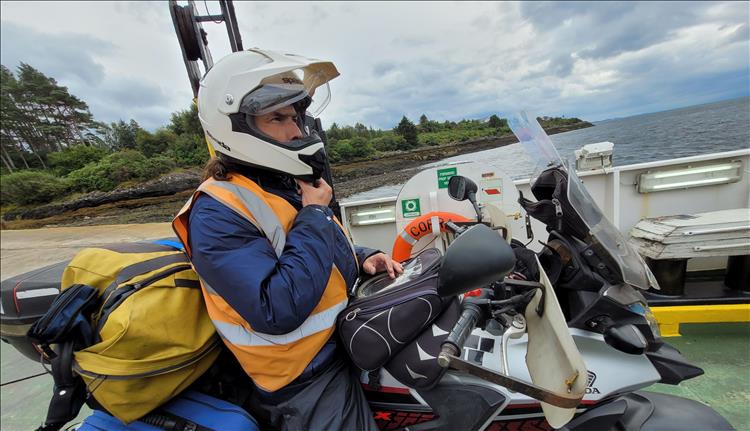 Ren sat on the bike on the ferry with a serious look on his face