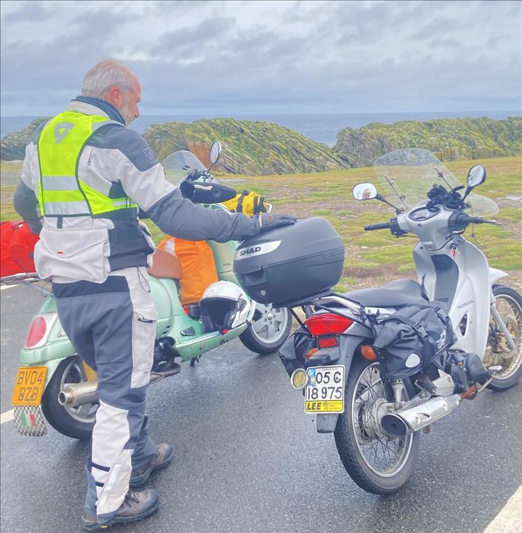 Mick's scooter riding friend looks out over the land a sea at the Butt of Lewis