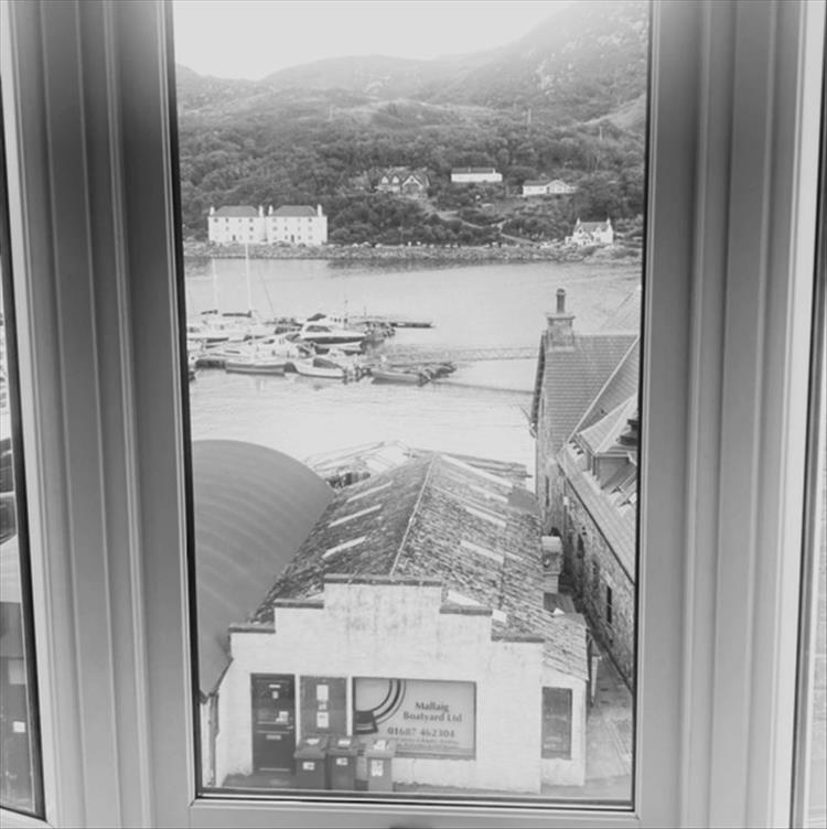 Looking out the window we see both the workings of the Habour and the hills behind