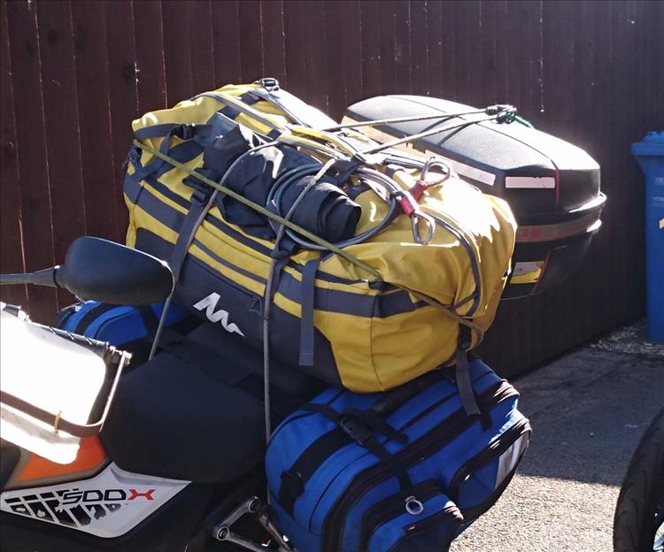 A big 80 litre yellow bag bungeed onto the rear seat of the 500