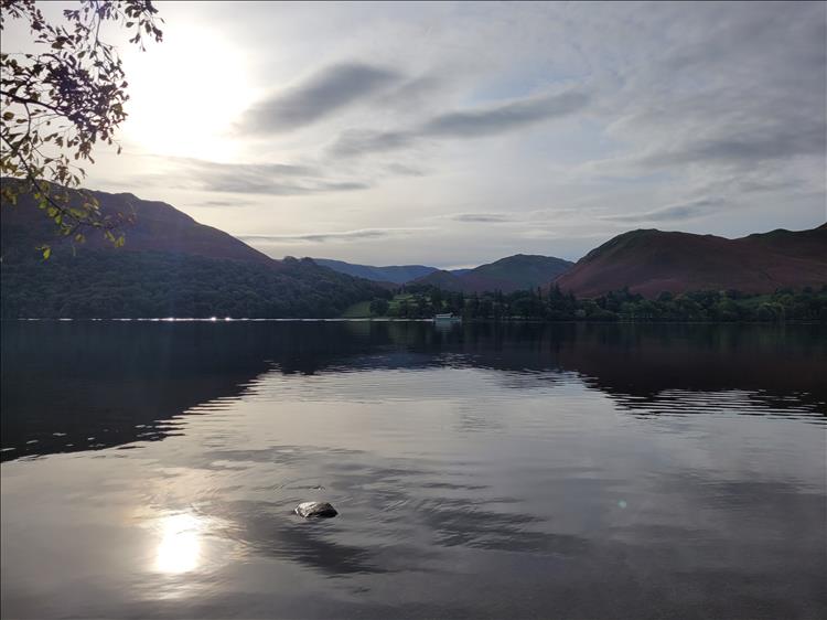 Ullswater is totally flat and quiet save for a small tourist boat in the distance