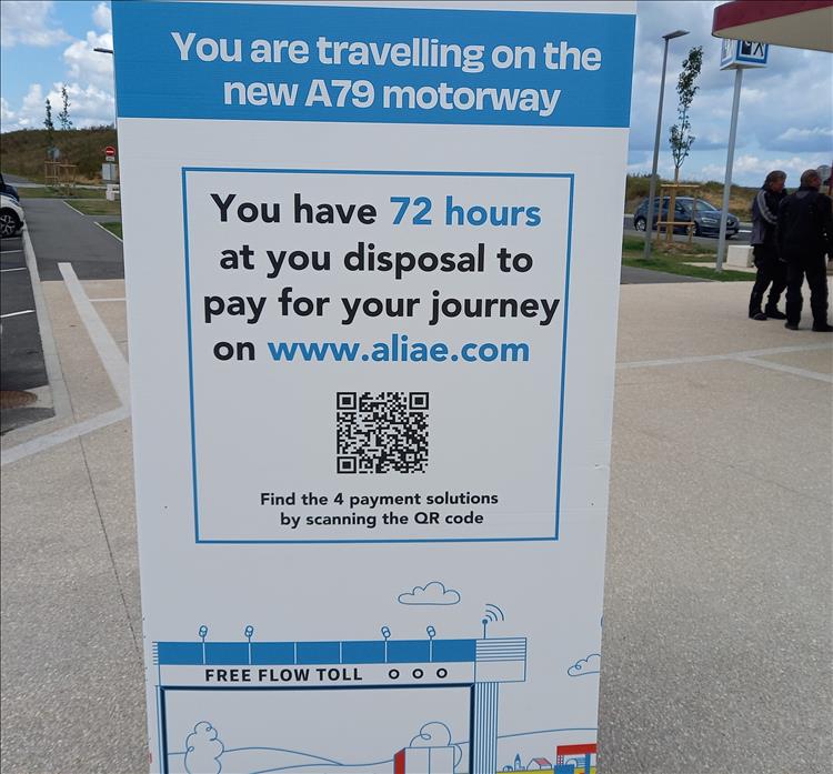 A sign in English explaining the motorway tolls and how to pay