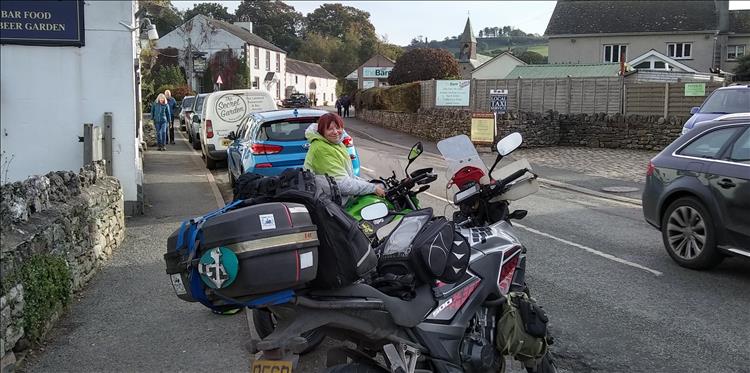 Sharon smiles as she retrieves her tank bag from the 250