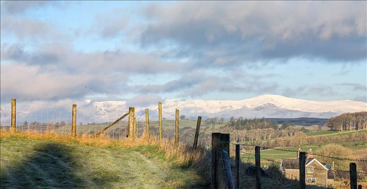 Snow capped mountains and rolling clouds around Snowdonia in March