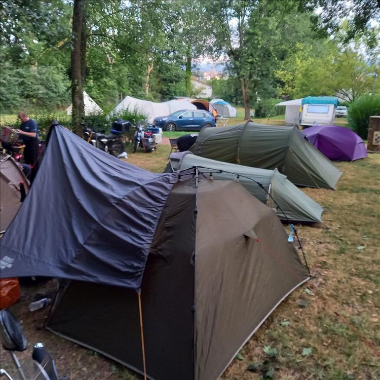 many tents and motorcycles between the other camper's caravans and large tents