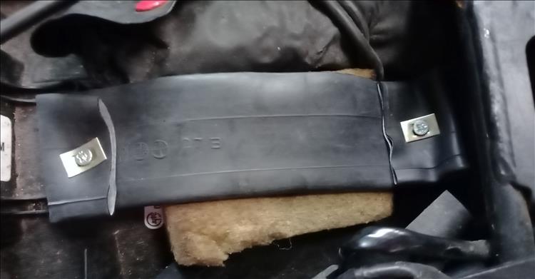 A rubber strip, an old sponge and the underside of the seat