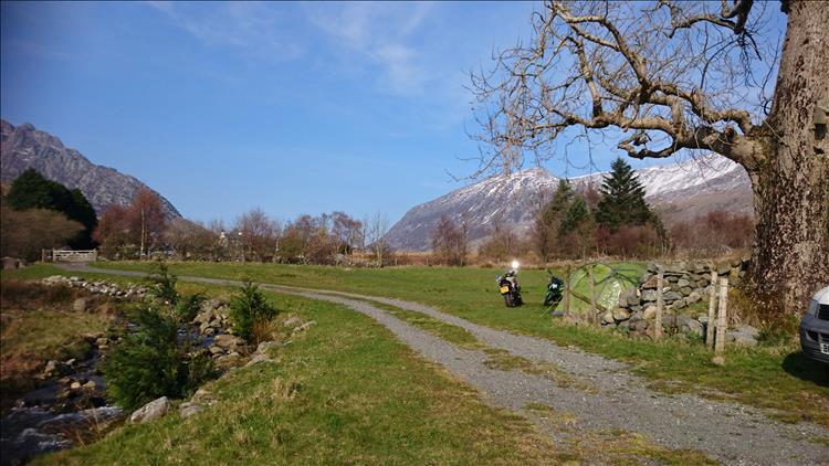 Snow capped mountains, wonderful countryside, the bikes and the tent under blue skies