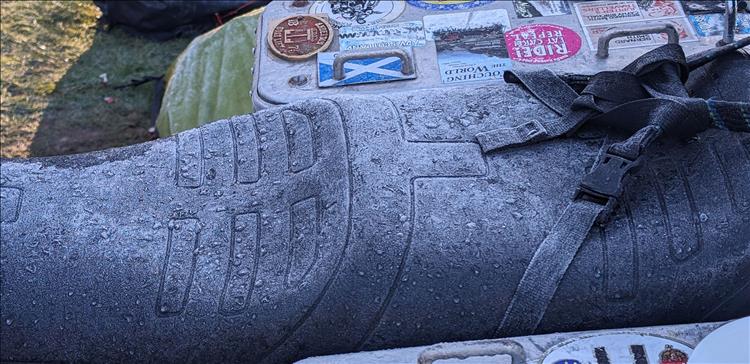 A seat covered in frost and ice in the cold morning's light