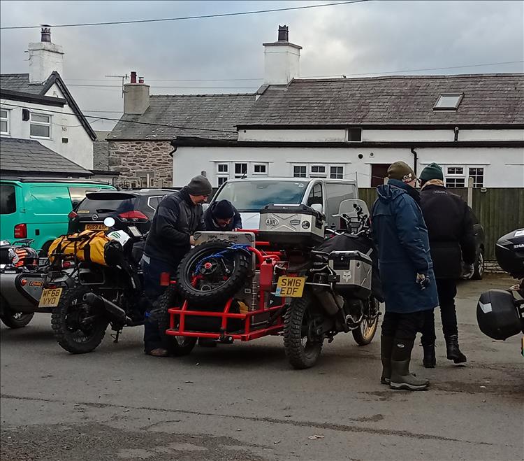 A large adventure bike with a large tubular steel sidecar filled with luggage