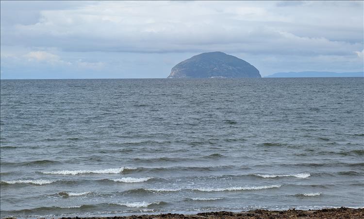 A small island in the sea like a bulbous rocky bubble